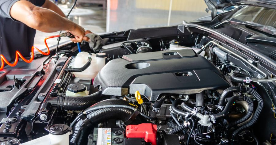 Operario tocando el motor de un vehículo. Enlace de artículo: “Tecnología aplicada al sector del metal para mejorar la seguridad”.